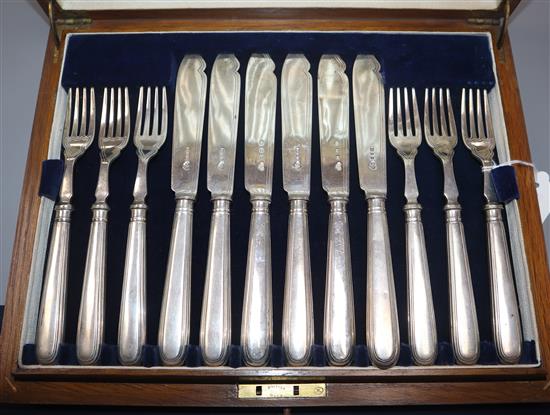 Twelve pairs of silver fish knives and forks, hollow handles, London 1928, in oak canteen.